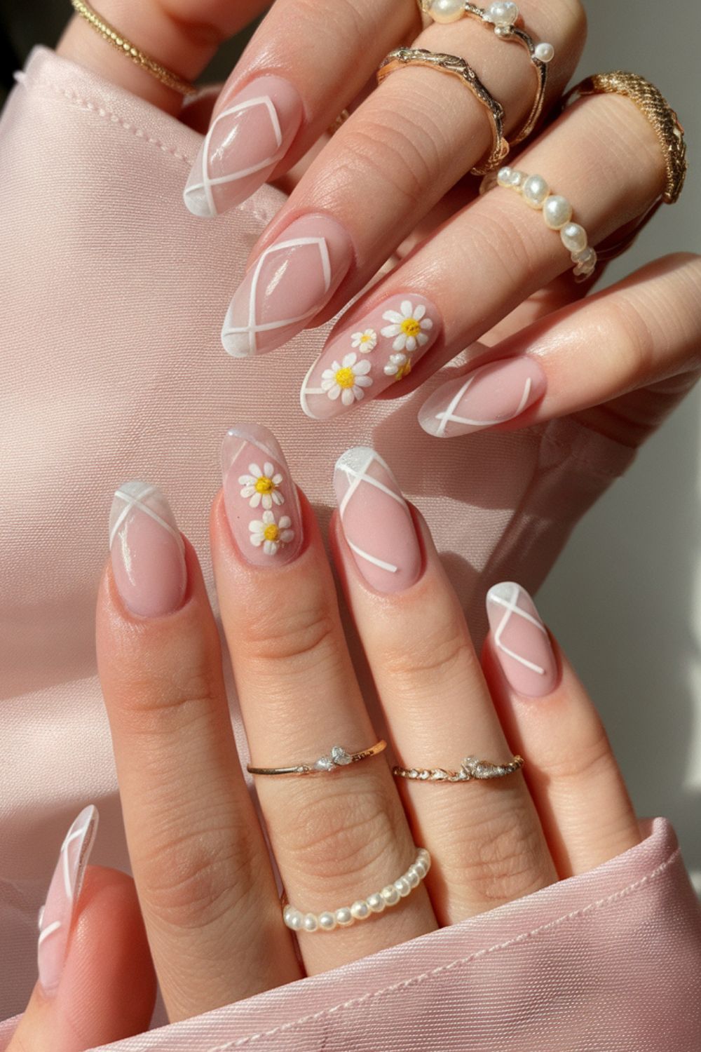 Chic Nude Almond Nails with White Geometric Lines & Daisy Art