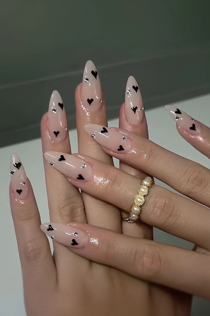 Chic Stiletto Nude Nails with Black Hearts & Sparkling Rhinestones