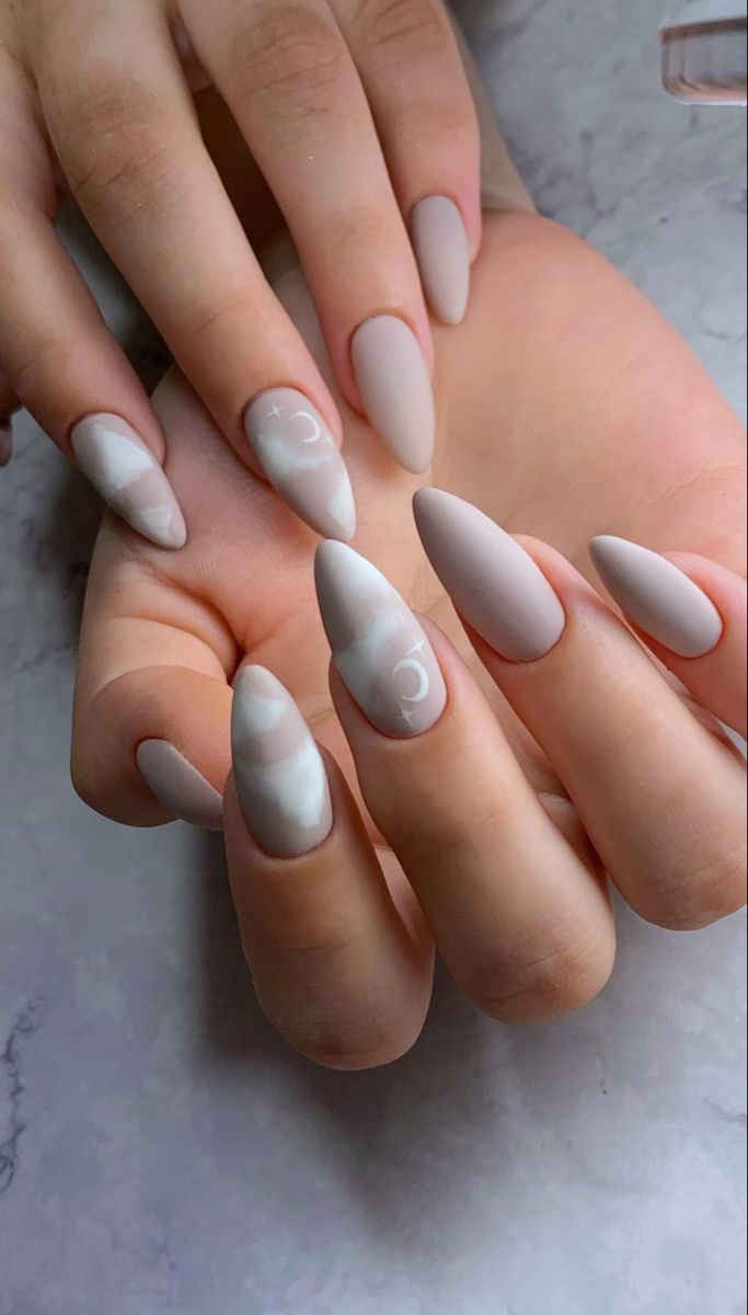 Dreamy Matte Beige Almond Nails with White Celestial Designs