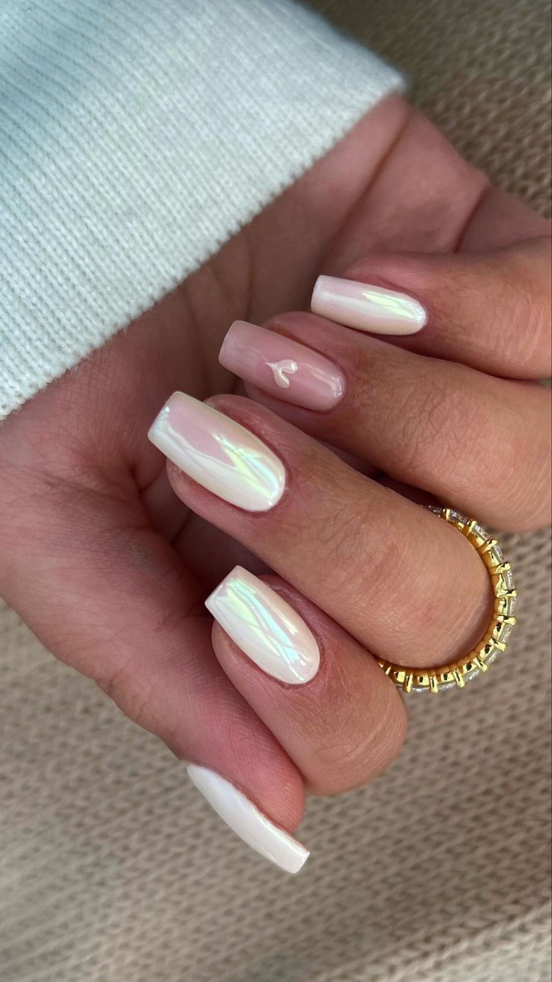 Iridescent Pearl Pink Nails with Subtle Heart Accent Design for a Luminous Look