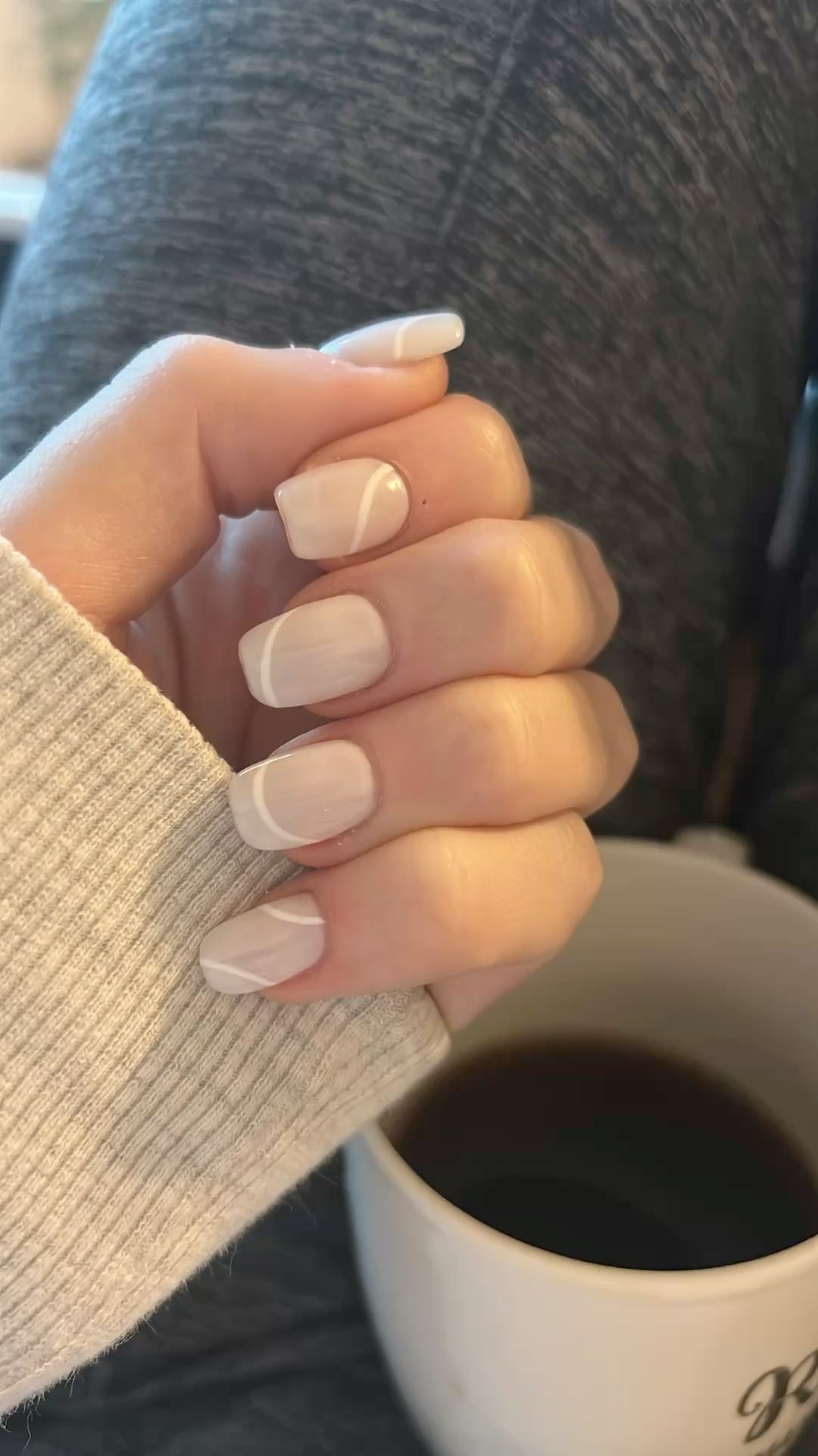 Chic Milky Beige Squoval Nails with White Swirl Line Art
