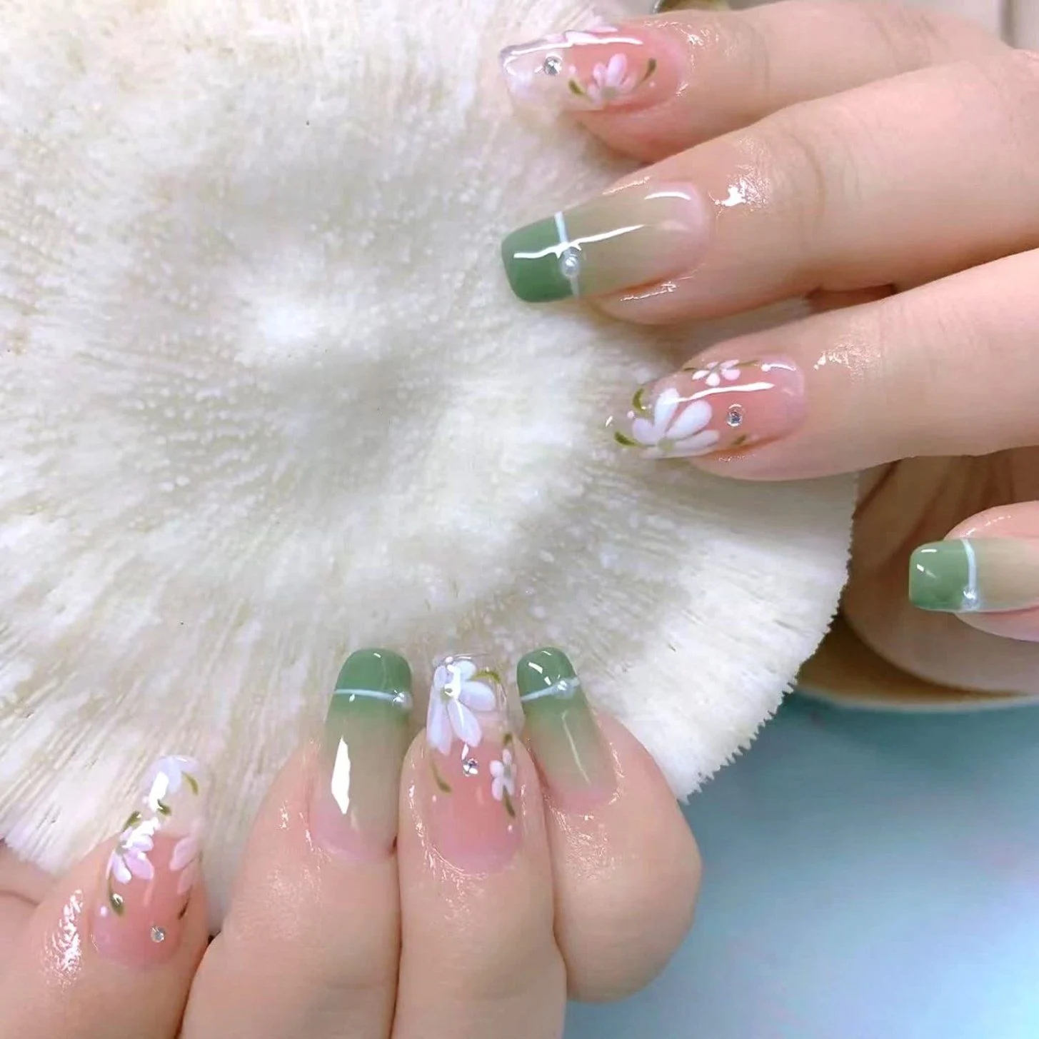 Delicate Green Ombre French Tip Nails with White Floral Art